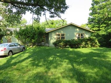 Ithaca apartment for rent - a green house with a car parked in front of it