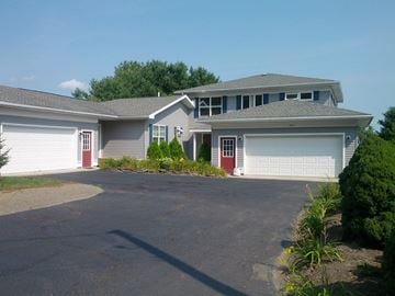 Ithaca apartment for rent - a house with a driveway and two garage doors