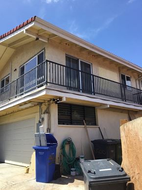 Honolulu apartment for rent - a house being remodeled with trash cans in front of it