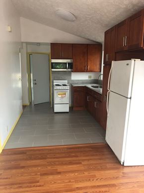 Honolulu apartment for rent - an empty kitchen with wooden floors and white appliances