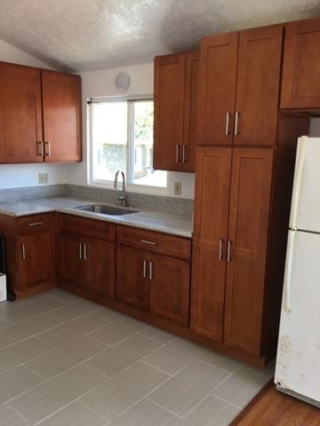Honolulu apartment for rent - an empty kitchen with wooden cabinets and a sink