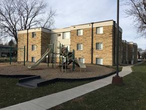 St Peter apartment for rent - A playground with a slide and a building in the background.