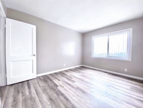 San Francisco apartment for rent - an empty room with wood floors and a door and window