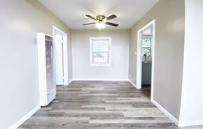 San Francisco apartment for rent - an empty living room with a ceiling fan and white walls