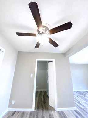 San Francisco apartment for rent - the living room with a ceiling fan and a door to the closet