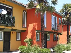 Newark apartment for rent - an orange house with palm trees in front of it