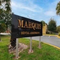 Tampa apartment for rent - A sign for Marquis Rental Agents is displayed in front of a building.