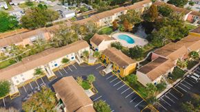 Tampa apartment for rent - A bird's eye view of a residential complex with a swimming pool.