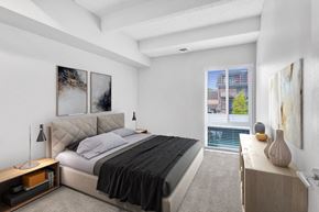Denver apartment for rent - a bedroom with a bed and a large window