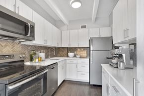Denver apartment for rent - a kitchen with stainless steel appliances and white cabinets