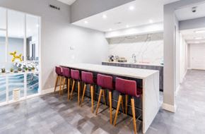 Inkster apartment for rent - the kitchen has a marble counter top and a row of red chairs
