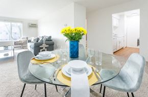 Inkster apartment for rent - a dining room with a glass table and chairs