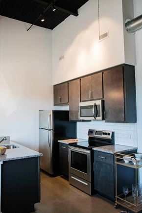 Norfolk apartment for rent - a kitchen with stainless steel appliances and black cabinets