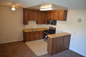 Sun Valley apartment for rent - an empty kitchen with wooden cabinets and a stove and a sink