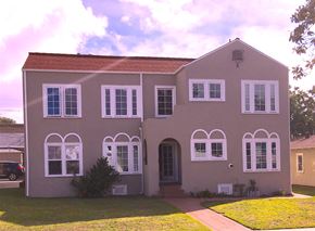 Glendale apartment for rent - a pink house with white windows and a lawn
