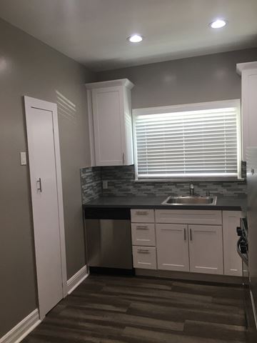 Glendale apartment for rent - a small kitchen with white cabinets and a sink