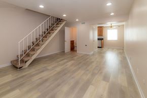 Glendale apartment for rent - A spacious room with wooden flooring and a staircase.