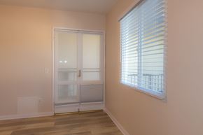 Glendale apartment for rent - A room with a sliding glass door and a window with blinds.