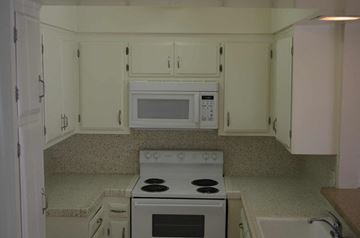 Sun Valley apartment for rent - a kitchen with white cabinets and a stove and a microwave