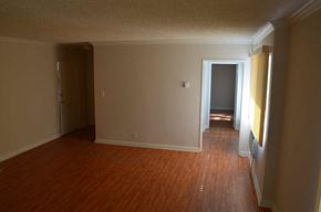 Sun Valley apartment for rent - an empty living room with wooden floors and a door to a hallway