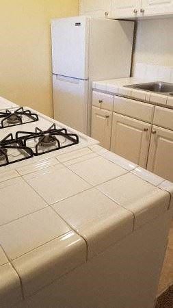 San Diego apartment for rent - a white kitchen with a stove and a sink