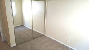 San Diego apartment for rent - a room with a carpeted floor and a mirrored closet