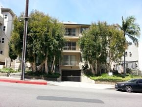 Los Angeles apartment for rent - A black car is parked on the side of a street.