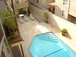 Los Angeles apartment for rent - A small pool in a balcony surrounded by chairs and plants.
