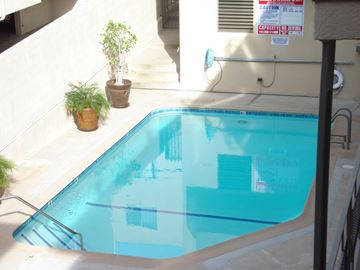 Los Angeles apartment for rent - A pool with a caution sign on the wall.