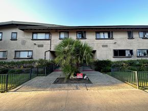 Van Nuys apartment for rent - A building with a red sign in front of it.