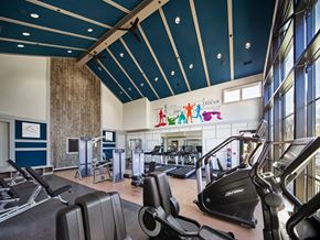 Trumbull apartment for rent - a gym with weights and cardio machines and a sign on the wall