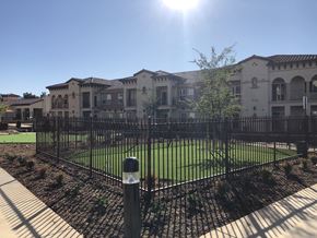 Yucaipa apartment for rent - a large apartment building behind a wrought iron fence