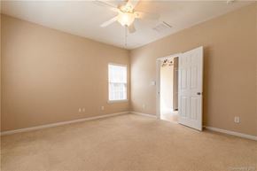 Cornelius house for rent - A room with a ceiling fan and a door.