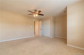 Cornelius house for rent - A room with a ceiling fan and carpeted floor.