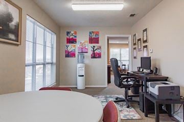 Maumelle apartment for rent - a living room with a table and a computer desk and a window