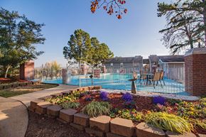 Maumelle apartment for rent - a swimming pool with a fence and chairs around it