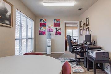 Maumelle apartment for rent - a living room with a table and a computer desk and a window