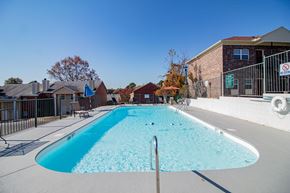 Little Rock townhouse for rent - our apartments have a large pool with a building in the background