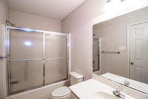 Maumelle apartment for rent - a bathroom with a shower toilet and sink and a mirror