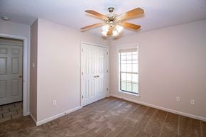 Maumelle apartment for rent - an empty living room with a ceiling fan and a window