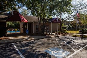 North Little Rock apartment for rent - an empty parking lot in front of a building with a swimming pool