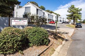Sherwood condo for rent - a row of houses with a sign in front
