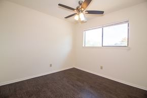 Sherwood condo for rent - an empty room with a ceiling fan and a window