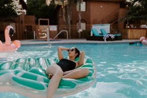 Davis apartment for rent - a woman laying on a raft in a swimming pool