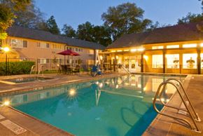 Davis apartment for rent - the pool is lit up at night in front of a hotel