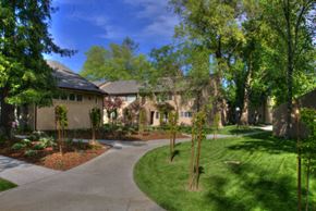 Davis apartment for rent - the front of a house with a driveway and trees