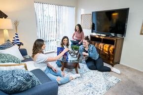 Davis apartment for rent - Residents play a game in a living room at Casitas
