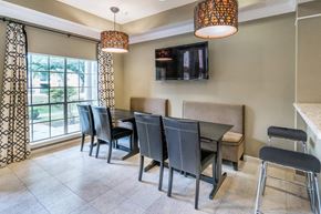 Baton Rouge apartment for rent - a dining room with a table and chairs and a tv