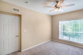 Baton Rouge apartment for rent - a bedroom with a ceiling fan and a window