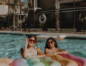 Davis apartment for rent - two women in a swimming pool with inflatable toys
